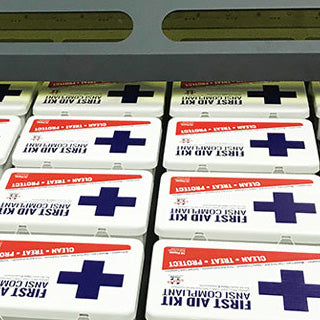 Rows of first aid kits organized neatly, showcasing essential medical supplies for emergencies.