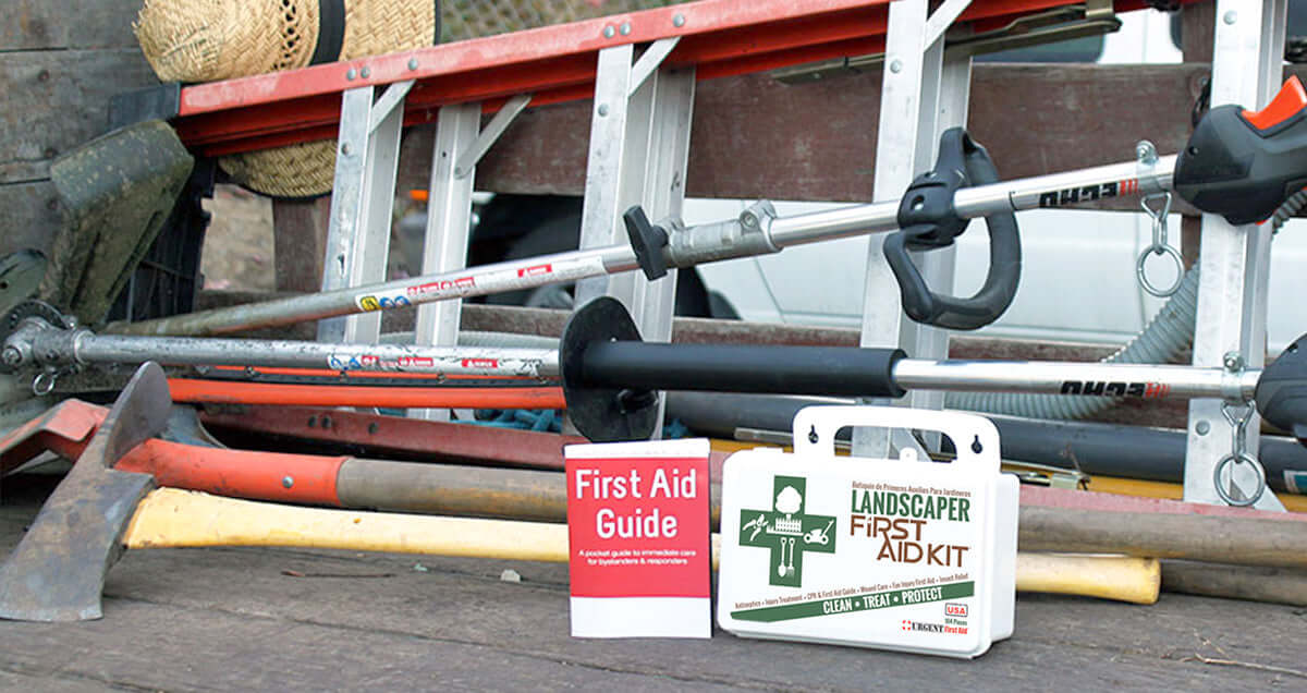 Landscaper's First Aid Kit 103 Piece, Plastic Case with tools and first aid guide on a workspace.